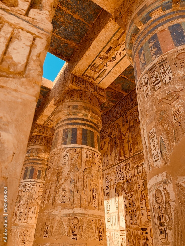 Massive columns inside beautiful Egyptian landmark with hieroglyphics, and ancient symbols. Famous landmark in the world near the Nile River and Luxor or Karnak, Egypt