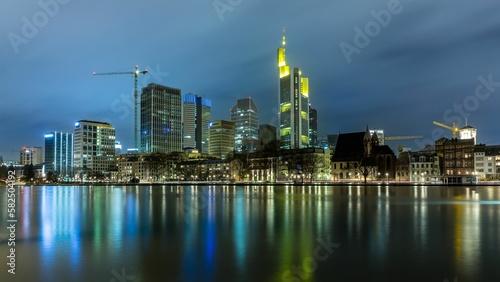View on Frankfurt skyline at night with reflection in the water, Germany © Frank Messmer/Wirestock Creators