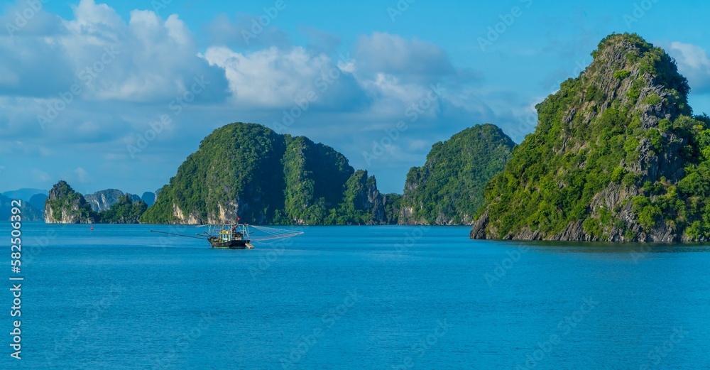 Rock formations with the landscape and boats view in Ha Long Bay, Vietnam
