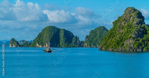 Rock formations with the landscape and boats view in Ha Long Bay, Vietnam © Jack Krier/Wirestock Creators