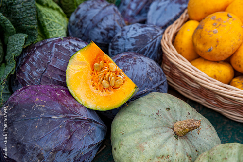 Pumpkin, Red cabbage and Kale
on display at a Market. One pumpkin is sliced open