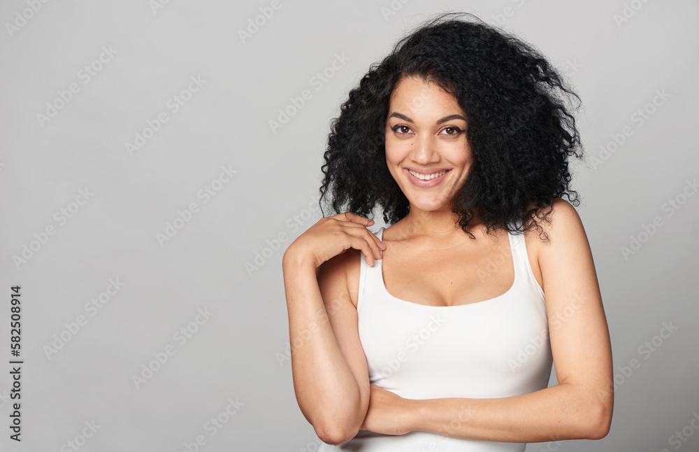 Happy playful mixed race girl on grey background Happy playful mixed race girl on grey background