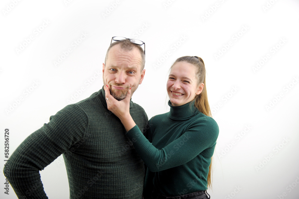 a happy loving couple fooling around and hugging at home in the kitchen. cozy and beautiful clothes for house. romantic relationships. psychological assistance to young families. Valentine's Day a happy loving couple fooling around and hugging at home in the kitchen. cozy and beautiful clothes for house. romantic relationships. psychological assistance to young families. Valentine's Day