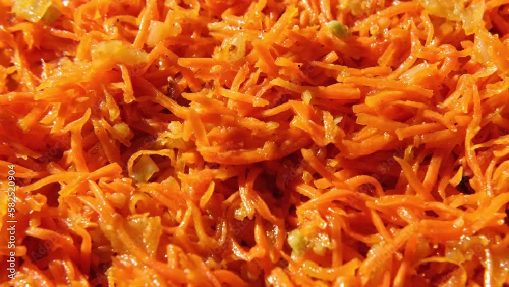Grated carrots background. Spicy Carrot salad with dressing and spices, onion, garlic. Cooked chopped carrot. Asian dish with condiments, pepper. Food wallpaper spinning. Oriental cuisine. Full Frame. Grated carrots background. Spicy Carrot salad with dressing and spices, onion, garlic. Cooked chopped carrot. Asian dish with condiments, pepper. Food wallpaper spinning. Oriental cuisine. Full Frame.