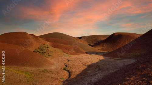 Foto Sunset on the red hills. Arid lands