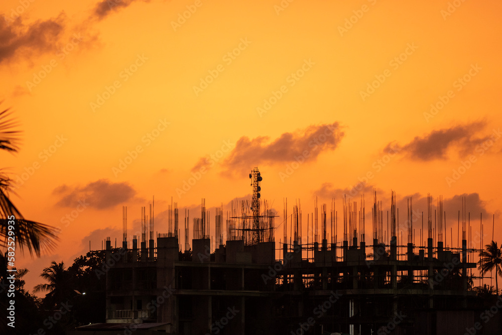 Silhouette of a construction site at sunset