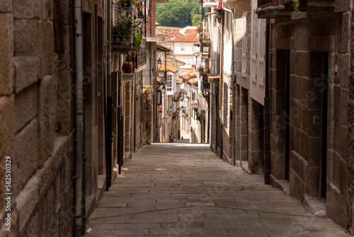 Fototapeta Naklejka Na Ścianę i Meble -  The narrow and winding old streets of Galicia, Spain, lined with historic architecture and cobbled paths, offer a glimpse into the region's rich history and culture
