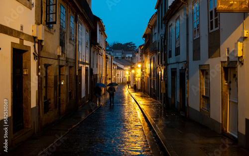 The rain-soaked plazas and historic buildings of Santiago de Compostela, Spain, take on a glistening beauty under the glow of streetlights