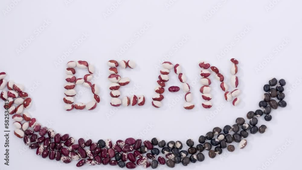 Out of pile of beans formed word bean with smile and, love crops, multicoloured seeds, agriculture, nutritious food, healthy diet, protein, vegetables. Close up, 4K Ultra HD. Out of pile of beans formed word bean with smile and, love crops, multicoloured seeds, agriculture, nutritious food, healthy diet, protein, vegetables. Close up, 4K Ultra HD.