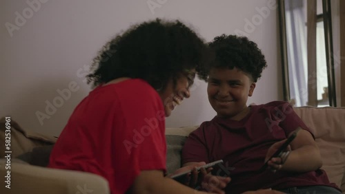 Woman and Son Using Smartphones Laughing