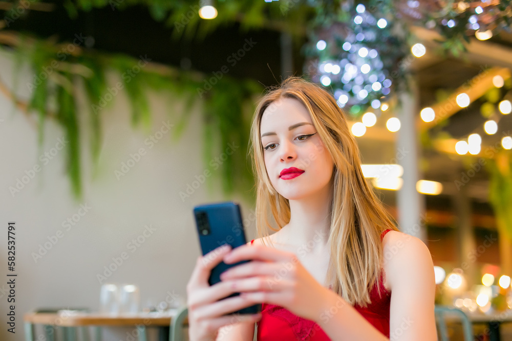 Serious woman using mobile phone in a bar Serious woman using mobile phone in a bar