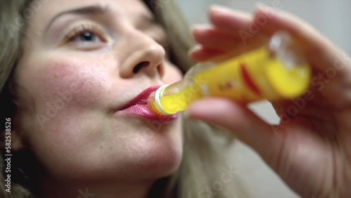 Wallpaper Mural Woman drinking ginger immunity shot at home Torontodigital.ca