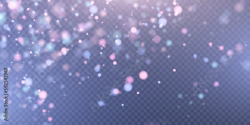 Light effect with lots of glittery highlights shining on transparent background for christmas new year design. Shiny bokeh dust particles fall off slightly. Fantastic shimmery effect.