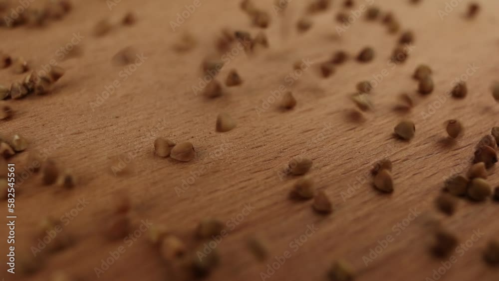 buckwheat groats close-up slowly pouring on the table background food video for cooking