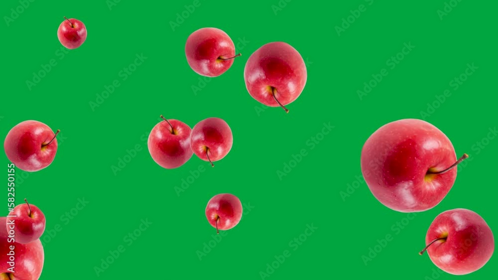 Abstract explosion with red Apples flying in different directions on a green background. Simple colorful food animation concept with vegetables Abstract explosion with red Apples flying in different directions on a green background. Simple colorful food animation concept with vegetables