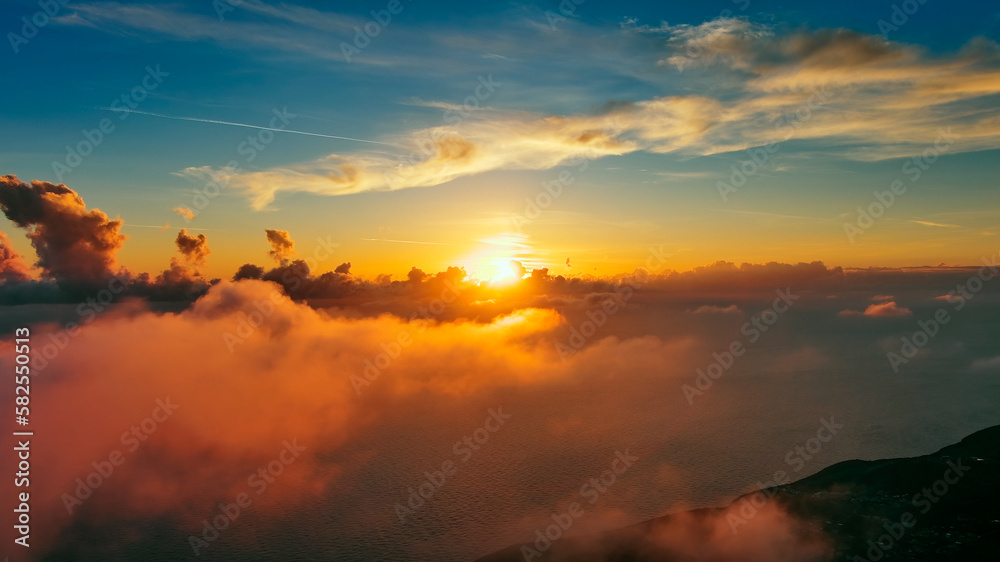 Flying in bright sunset clouds