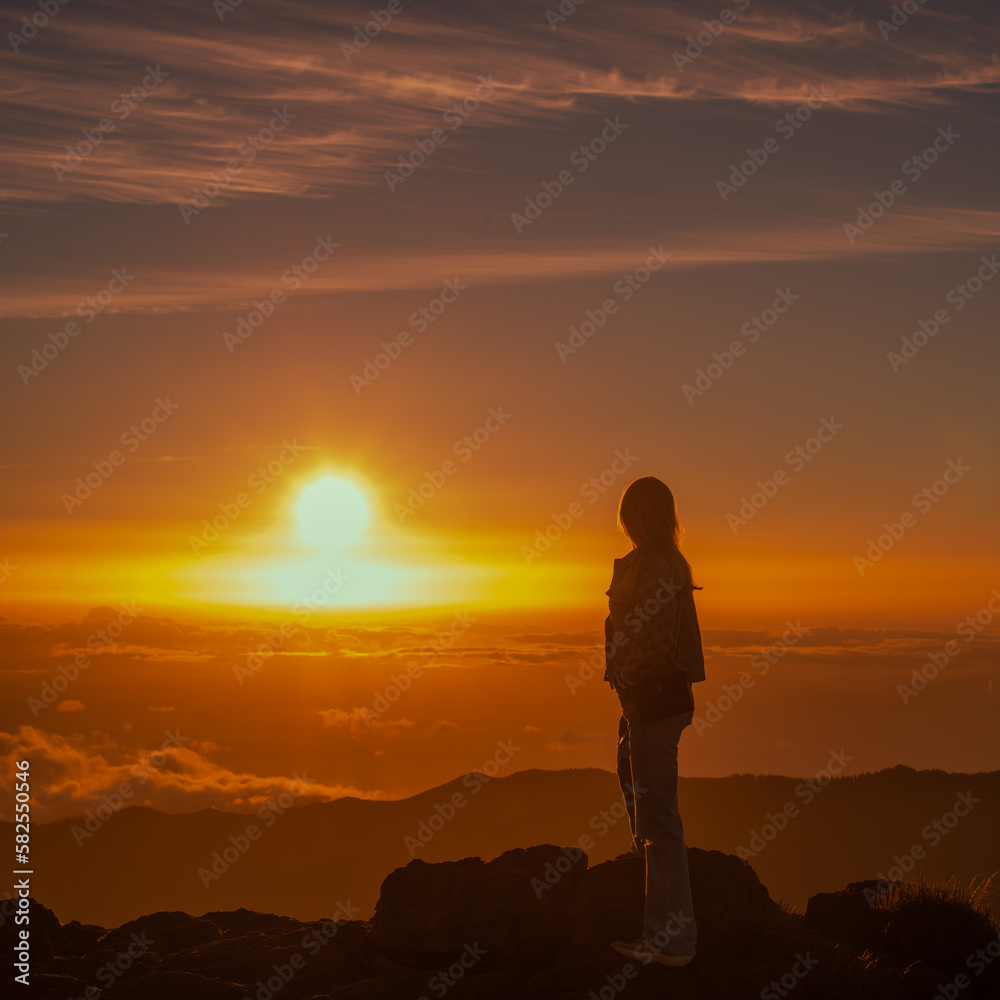 silhouette of person standing on top of mountain