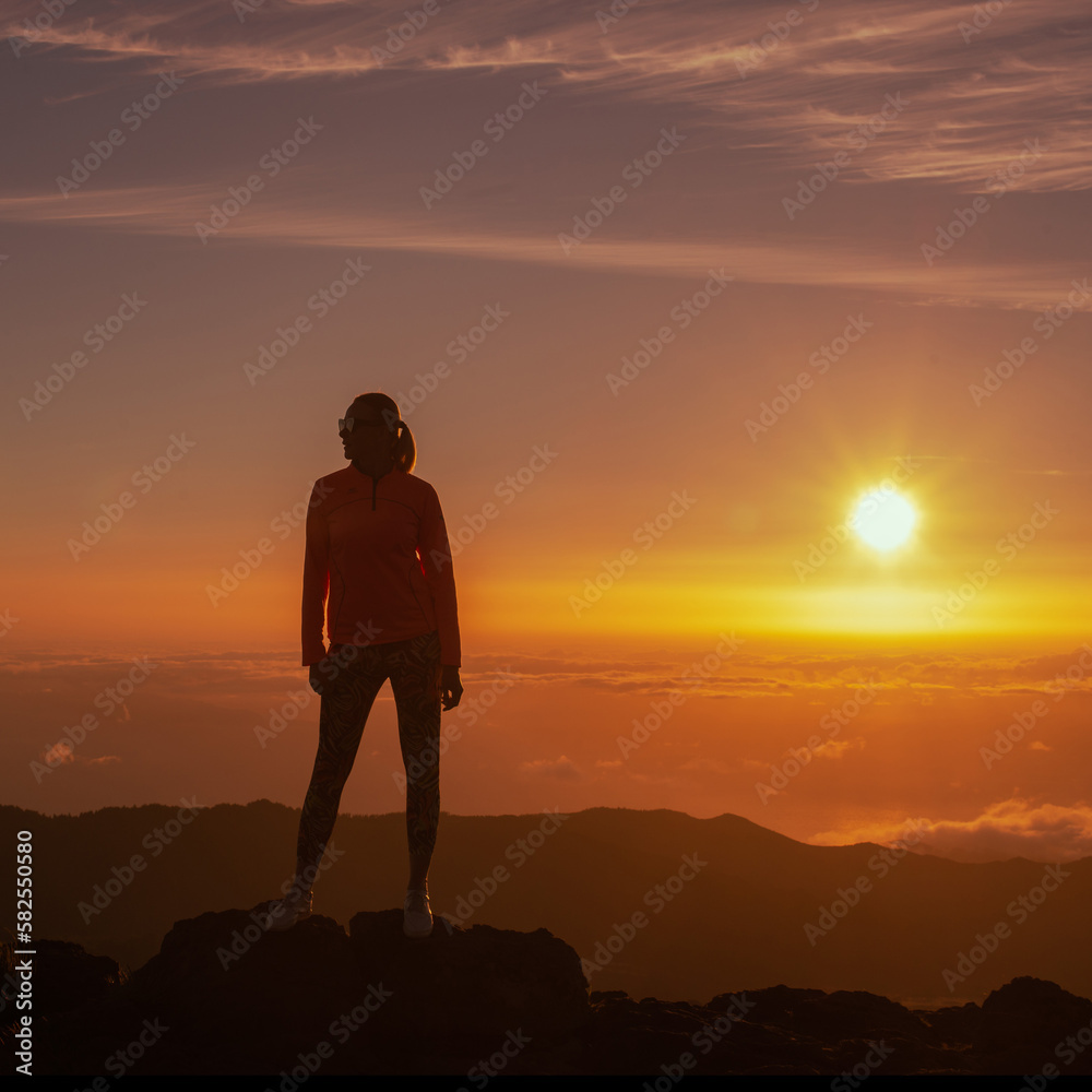 silhouette of person standing on top of the mountain