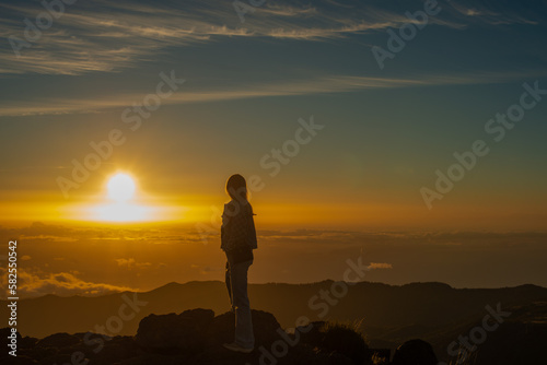 women stay and look sunrise
