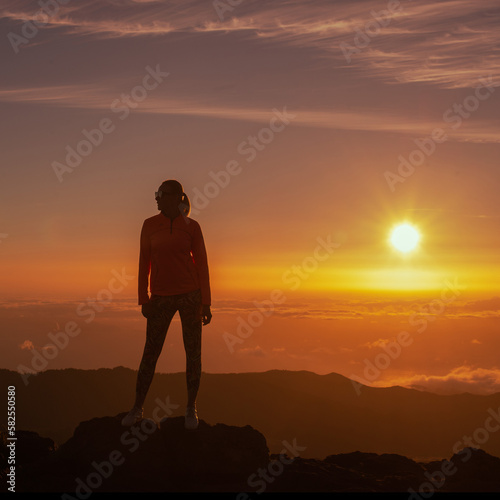 silhouette of person standing on top of the mountain