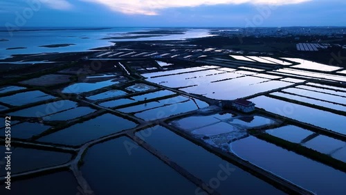 Landscape at sunset. Aerial view from a drone of the landscape of marshes and salt flats of the Ria Formosa Natural Park. Atlantic Ocean. Algarve. Portugal. Europe