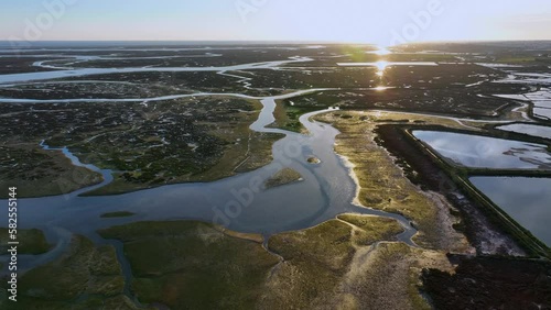 Landscape at sunset. Aerial view from a drone of the landscape of marshes and salt flats of the Ria Formosa Natural Park. Atlantic Ocean. Algarve. Portugal. Europe