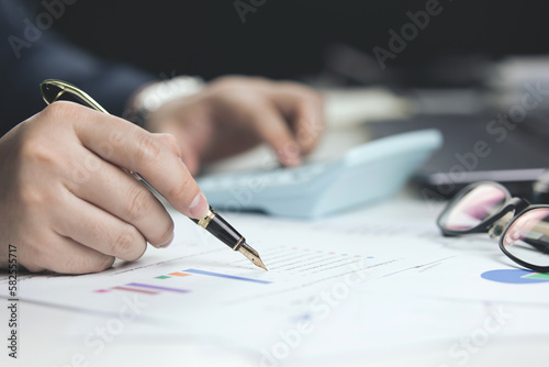 Male hand doing accounting, calculating bills, and expenses at home. Family budget bill payment checklist concept, pay bill check, income allocation plan, or Family budget hedge plan. © Midnight Studio