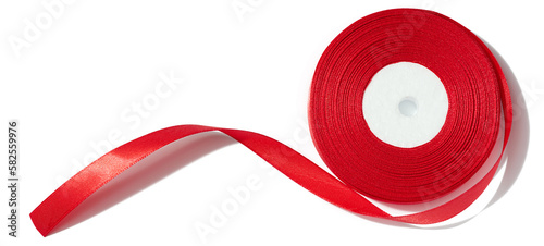 Φωτογραφία A spool with a red silk ribbon on a white isolated background, an object for dec