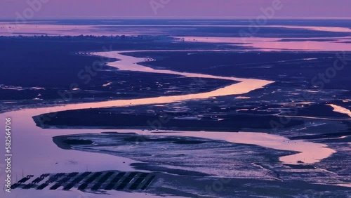 Landscape at sunset. Aerial view from a drone of the landscape of marshes and salt flats of the Ria Formosa Natural Park. Atlantic Ocean. Algarve. Portugal. Europe