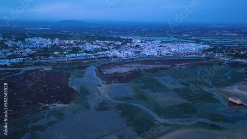 Landscape at sunset. Aerial view from a drone of the landscape of marshes and salt flats of the Ria Formosa Natural Park. Atlantic Ocean. Algarve. Portugal. Europe