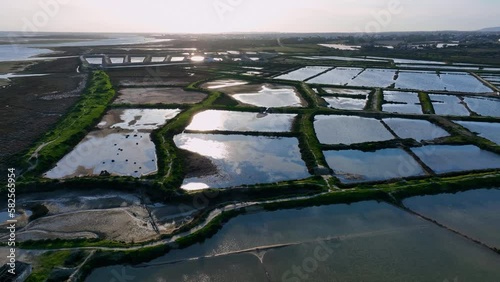 Landscape at sunset. Aerial view from a drone of the landscape of marshes and salt flats of the Ria Formosa Natural Park. Atlantic Ocean. Algarve. Portugal. Europe
