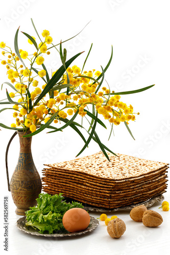 Jewish holiday Pesach  Passover . Matzah  Acacia dealbata flowers  walnuts and other attributes of the holiday on white background.