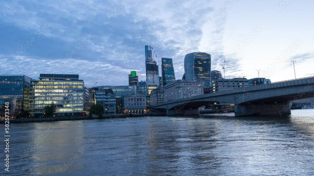 Morning shot of bridge over Thames river and modern business buildings on waterfront at sunrise. Low angle hyperlapse shot. London, UK Morning shot of bridge over Thames river and modern business buildings on waterfront at sunrise. Low angle hyperlapse shot. London, UK
