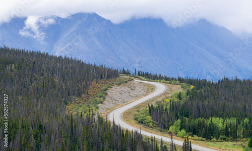 Scenic Road in the Canadian Nature Mountain Landscape during Fall Season. Taken in Yukon, Canada.