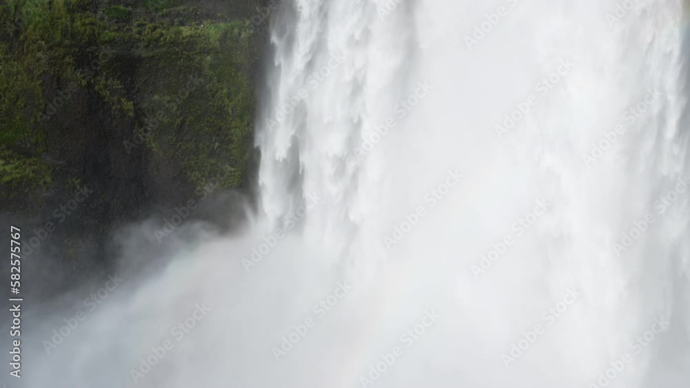 Skogafoss waterfall in Iceland, Water flowing through cliffs, Famous attraction. Huge mountain river. Nature spring landscape. Shot in 8k resolution 4320p. Skogafoss waterfall in Iceland, Water flowing through cliffs, Famous attraction. Huge mountain river. Nature spring landscape. Shot in 8k resolution 4320p.