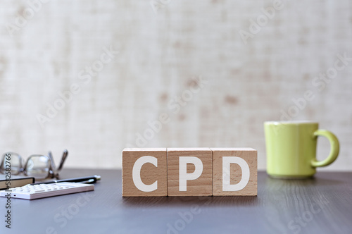 There is wood cube with the word CPD. It is an acronym for Continuing Professional Development an eye-catching image. photo