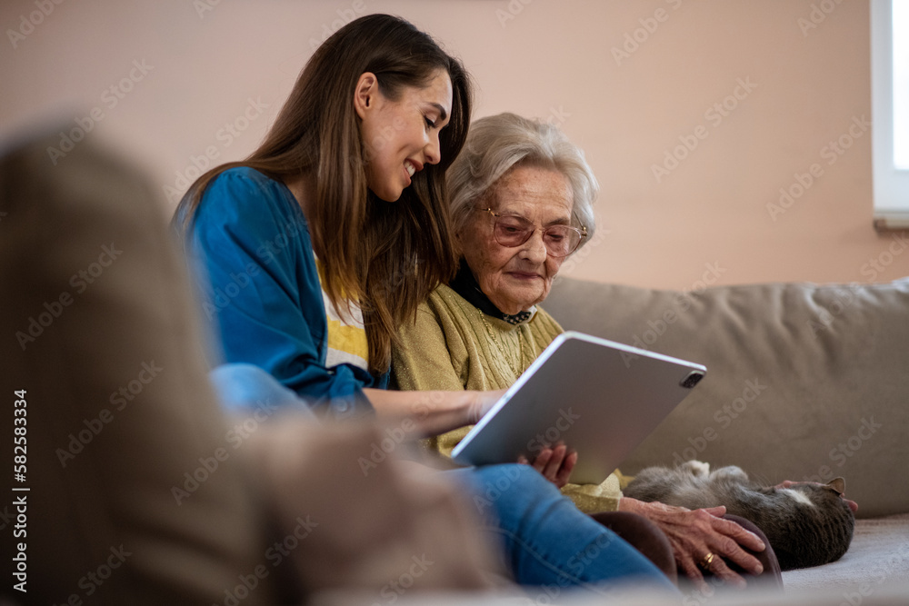 Nurse and senior woman reviewing medical records on a digital tablet. Nurse and senior woman reviewing medical records on a digital tablet.