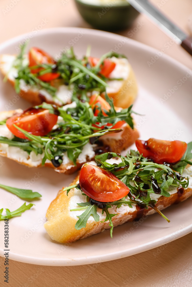 Plate of delicious sandwiches with cream cheese, arugula and tomatoes, closeup Plate of delicious sandwiches with cream cheese, arugula and tomatoes, closeup