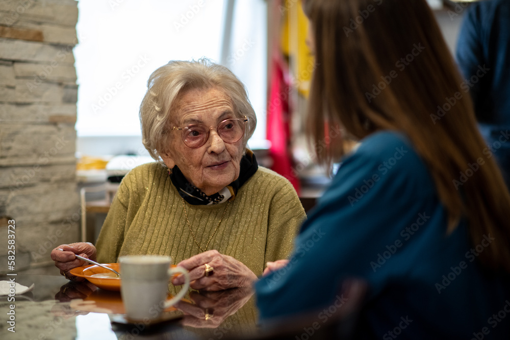 Nurse assisting senior woman with mealtime routine at a retirement home. Nurse assisting senior woman with mealtime routine at a retirement home.