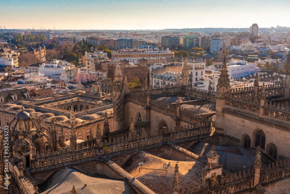 Details of the Cathedral and the chapel of Seville from the rooftop of the church with the historic cityscape in the background