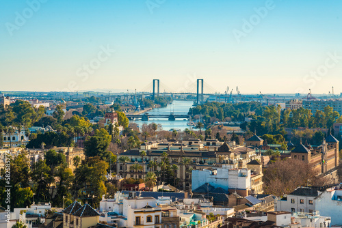 View of Seville harbor, university and hanged bridge by canal Alfonso, from the top of la giralda photo