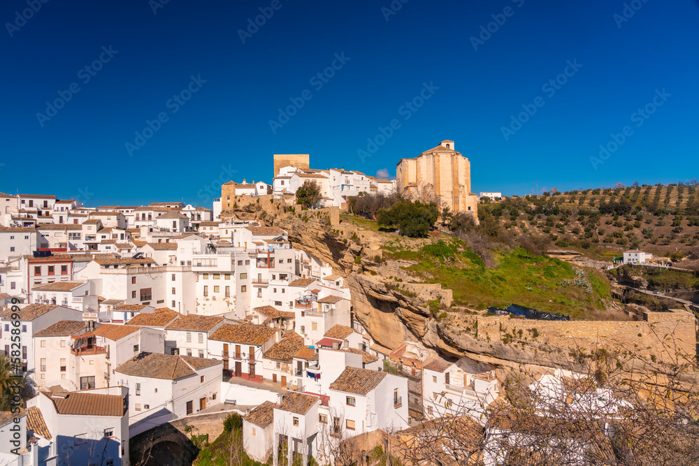Overview of The historic village of Setenil de las Bodegas in the province of Cadiz with the monastery on the top of the hill
 