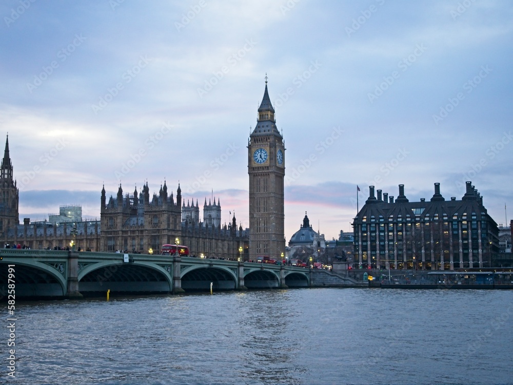 Naklejka premium Big Ben looms over the Westminster Bridge and the Palace of Westminster, home of the UK parliament.