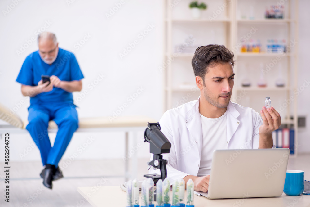 Fototapeta premium Two male chemists in drugs synthesis concept