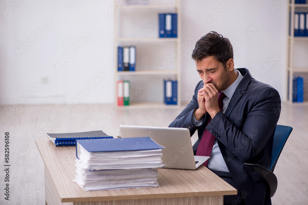 Young male employee working in the office Young male employee working in the office
