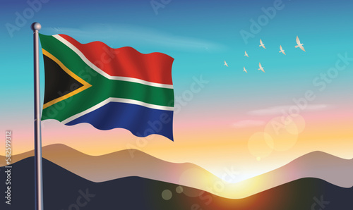 South Africa flag with mountains and morning sun in background © Ben75
