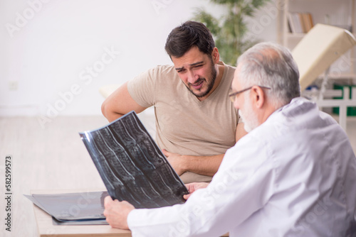 Young male patient visiting old male doctor radiologist