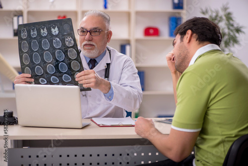 Young male patient visiting old male doctor radiologist