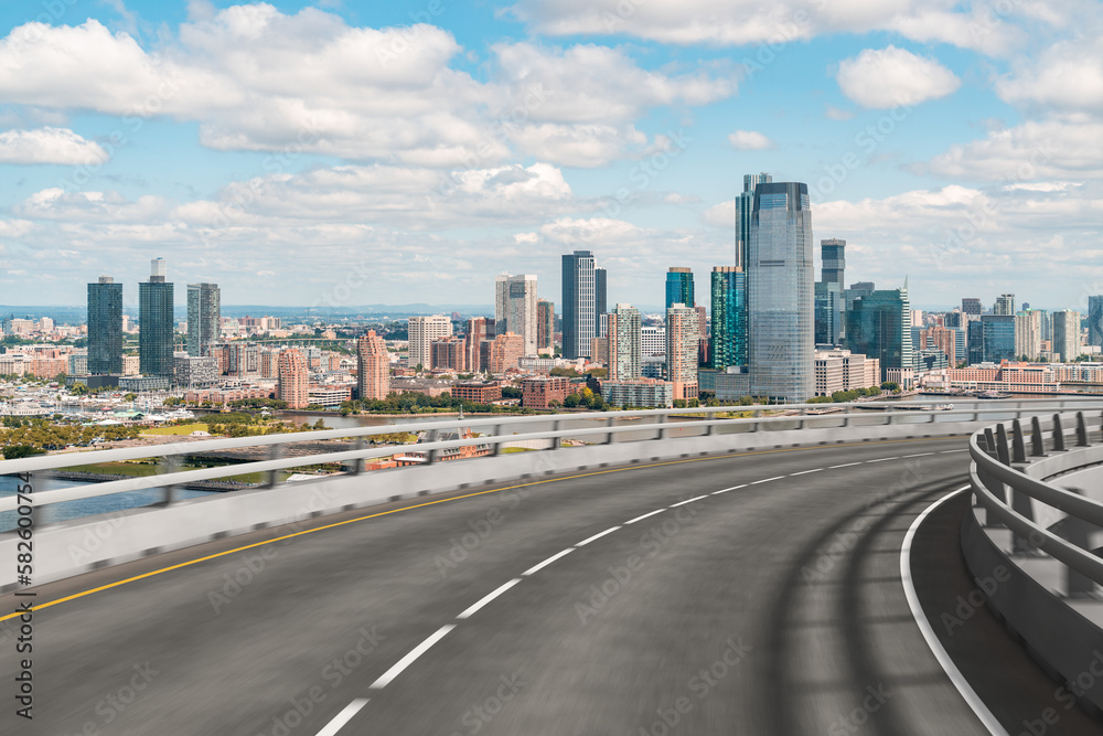 Empty urban asphalt road exterior with city buildings background. New modern highway concrete construction. Concept of way to success. Transportation logistic industry fast delivery. New York. USA. Empty urban asphalt road exterior with city buildings background. New modern highway concrete construction. Concept of way to success. Transportation logistic industry fast delivery. New York. USA.