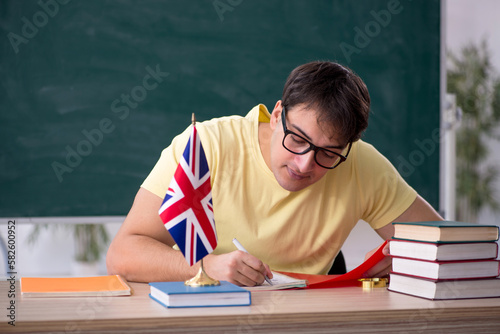 Young male English language teacher in the classroom